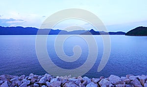 Sky, mountains, stone wall and peaceful lake