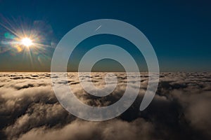 Sky over clouds from a plane over Montenegro. Aerial photography of blue sky and sun over clouds