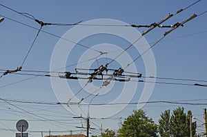 The sky over the intersection with many trolleybus wires