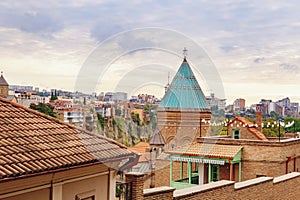 Sky over the Tbilisi Old Town neighborhood with a view on church tower and vivid red rooftops. Tbilisi, Georgia