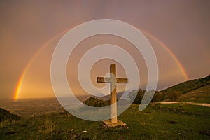 The sky of paradise with wonderful rainbow and cross