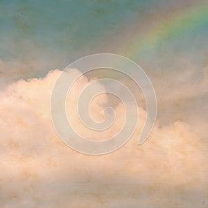 Sky rainbow clouds on a textured, vintage paper background with