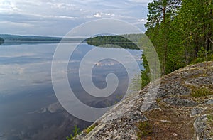 The sky is reflected in the smooth surface of the lake