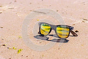Sky is reflected in sunglasses, beach