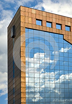 Sky reflection with clouds on the windows of the building