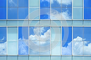 Sky reflection on surface of glass modern building wall