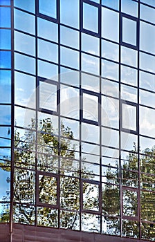 Sky reflections in the glass wall.