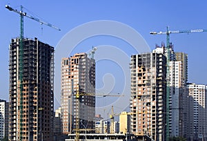 Sky-scrapers building cranes