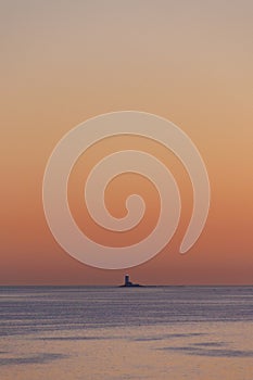 sky and sea view, Lighthouse against shining orange sunset. background of nature