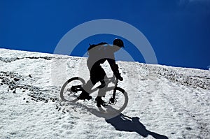 Sky, snow and mountain biker