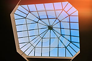 Sky through a square window in the ceiling of the building. Big window in the roof of the hotel