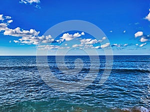 Sky sun cloud heaven background sea. Sea shore with small waves. Blue sea. Sea waves with clear blue sky. Pacific ocean blue calm