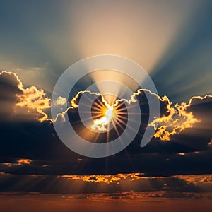 Sky with the sun setting behind dark clouds, creating radiant light