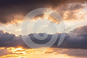 The sky at sundown, and thunderclouds. Sunlight streaming through the clouds. Atmospheric photo.