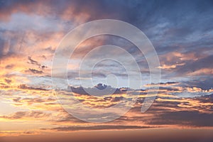 Orange and blue sunset sky with clouds glowing, perfect for background replacements photo