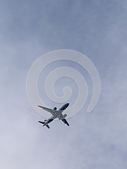 Sky Symphony - Ground View of Airplane Amidst Clouds