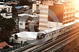 The Sky train in Bangkok with building, BTS Sky Train on rail tracks with traffic underneath