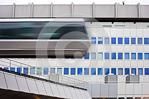Sky-Train passing fast in front of office building