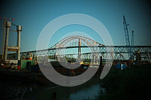 Sky trains from bottom up train of blue line passing against background of sky skytrain bridge in New Westminster Fraser