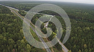 Sky view of summer road with cars and trucks. Summer forest and highway road drone view. Highway truck traffic