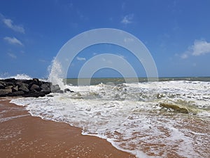 Sky water stone and sand at Negombo Beach, Sri Lanka.