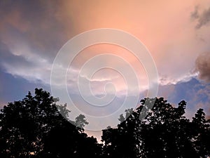 Sky with white rainy clouds in the green farmland. close up view of cloud,