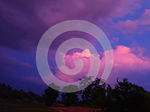 Sky with white rainy clouds in the green farmland. close up view of cloud,