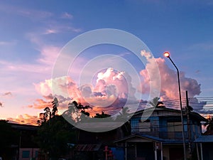 Sky with white rainy clouds in the green farmland. close up view of cloud,