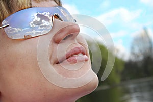 Sky in woman sunglasses