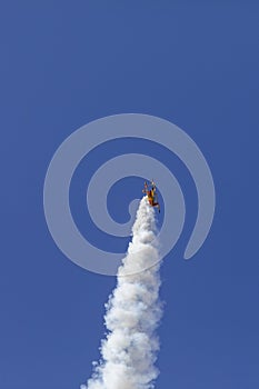 Skyaces plane performing Aerobatics with a smoke trail photo