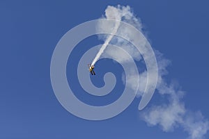 Skyaces plane performing Aerobatics with a smoke trail photo