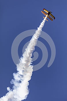 Skyaces plane performing Aerobatics with a smoke trail photo