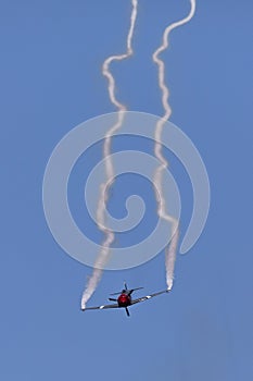 Skyaces plane performing Aerobatics with a smoke trail photo
