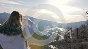 Skybridge observation deck. Woman enjoing sunlight and scenery view of the mountains