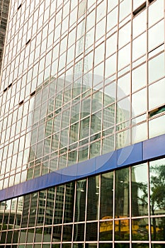 Skycraper reflextion on a modern glass building photo