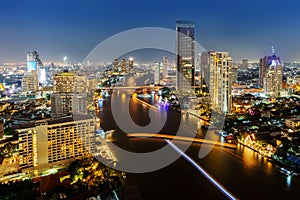 Skycrapper view of Bangkok city with rive at night time. photo