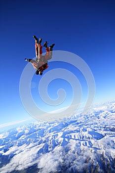 Skydive over snow mountain