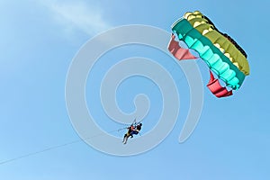 Skydive with umbrella in blue sky