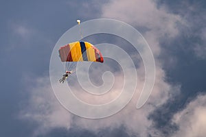 Multicolored parachute in blue sky