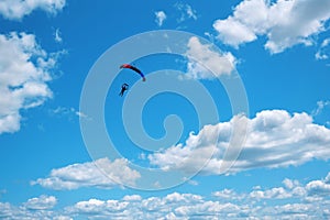 Skydiver with a black red blue canopy