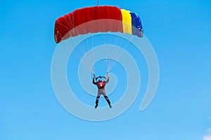 Skydiver and colorful parachute
