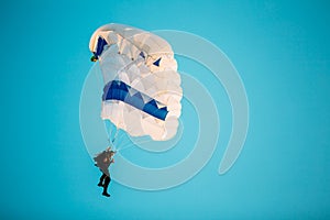 Skydiver On Colorful Parachute In Sunny Sky