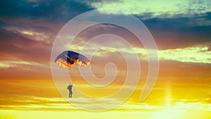 Skydiver On Colorful Parachute In Sunny Sunset Sky