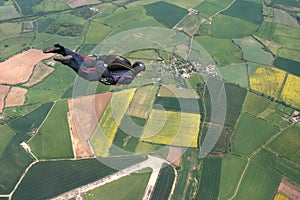 Skydiver flies past cameraman photo