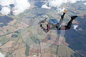 Skydiver in freefall high up in the air