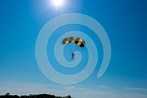 Skydiver jumper is landing with parachute
