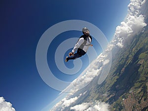 Skydiver jumping free with the clouds