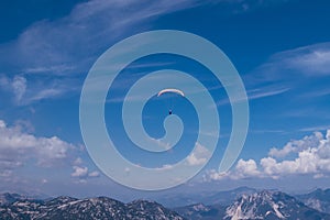 Skydiver is playing with his life overDachstein Krippenstein at a height of 2.5 km. A man with a parachute circles over the