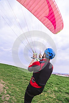 Skydiver pulls parachute behined him after landing