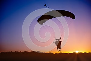 Skydiver silhouette under parachute